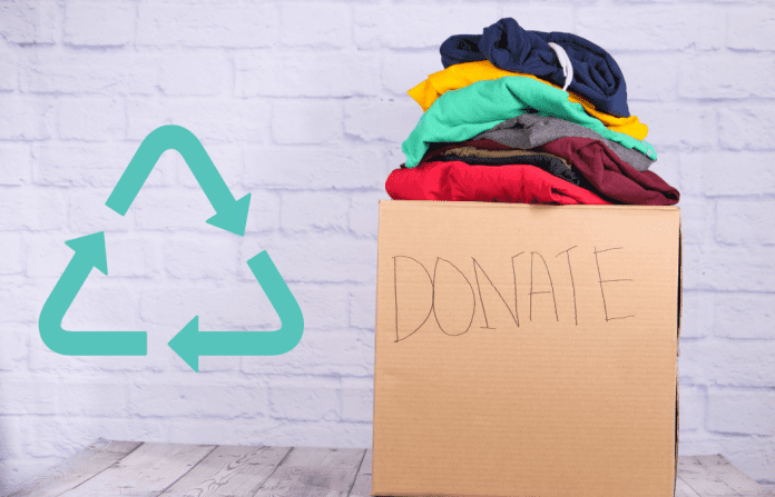 white chalk background with donation box of clothes and recycle symbol