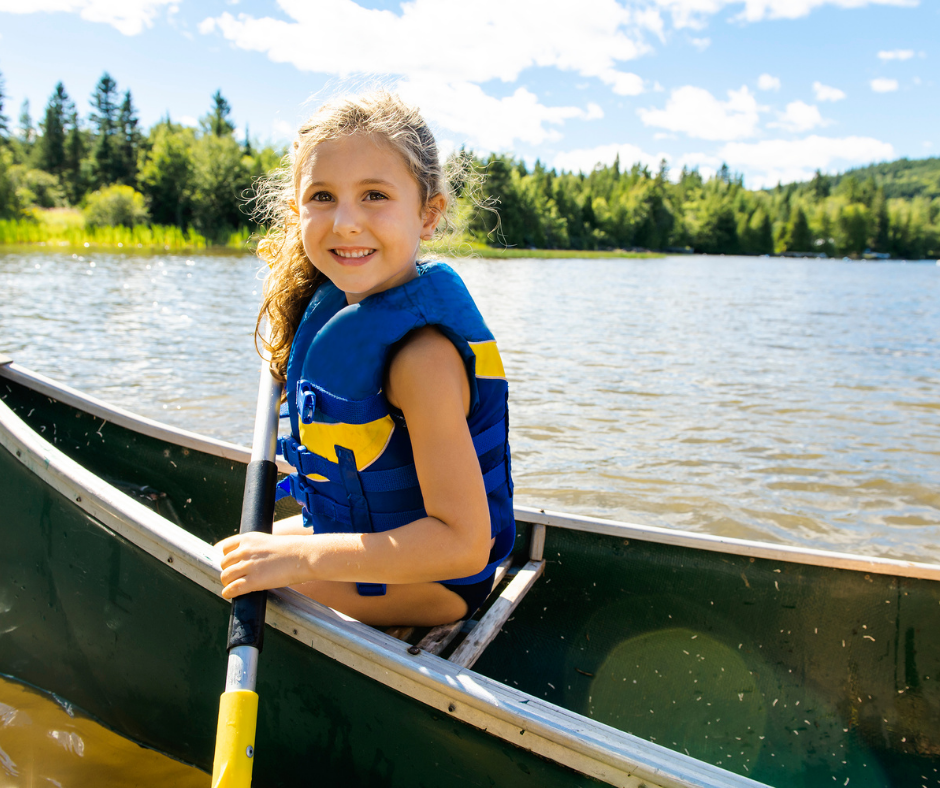 girl wearing life jacket in a canoe