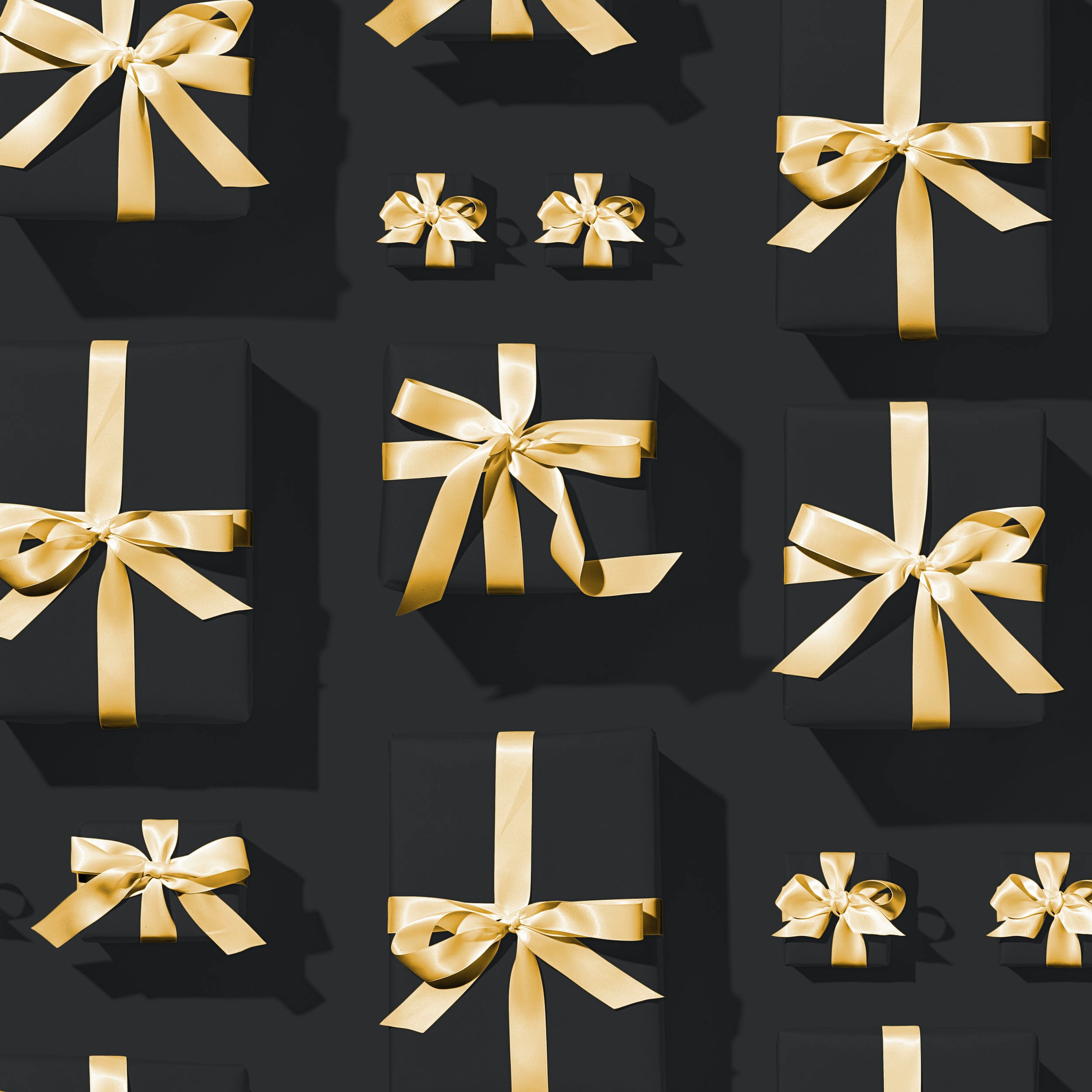 small black gift boxes with gold ribbon