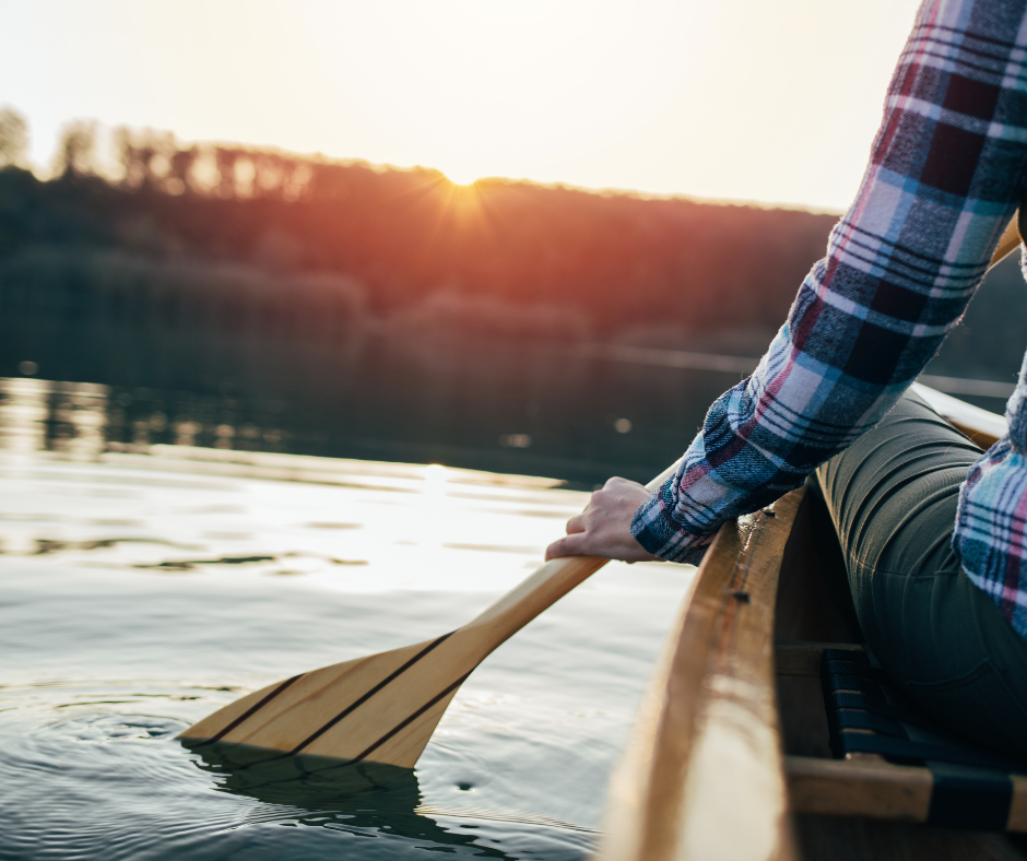 person holding a paddle on the water