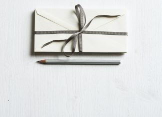 a gift with a bow and a pencil next to it