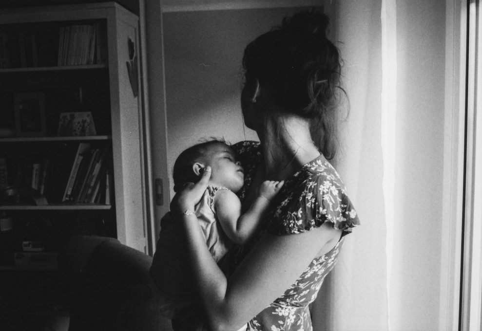 black and white photo of mother holding baby