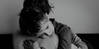 Transparent Parenting: The Day I Scared My Son with my Grief child hugging a parent in black and white