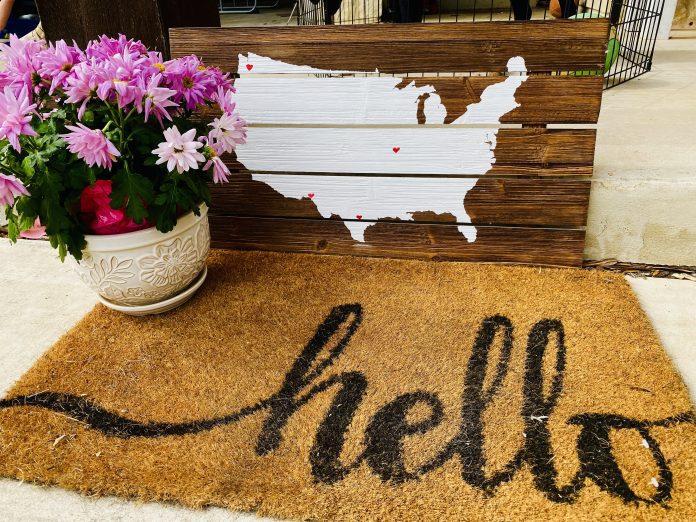 doormat with "hello" and flower pot with US map