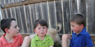 Three boys posing for picture