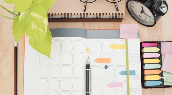 desktop with planner and notes and pens