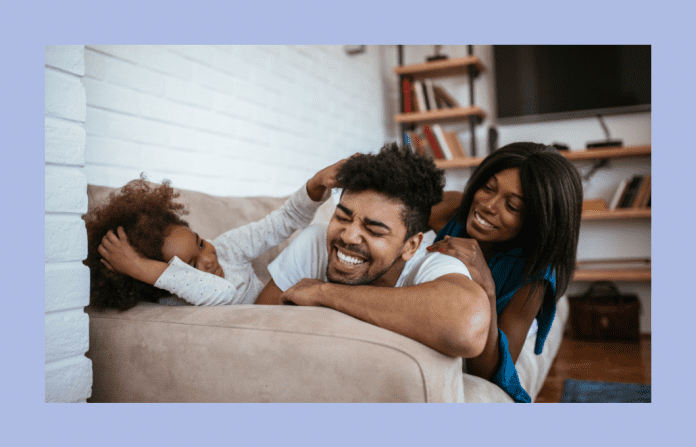 dad, mom, and child relaxing together in home