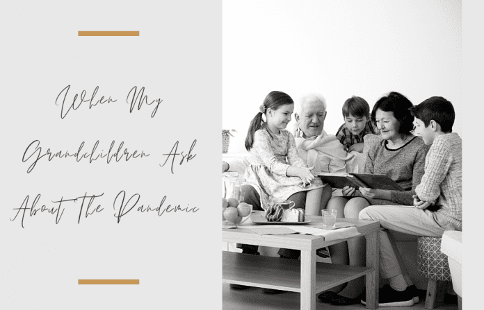 Grandparents and grandchildren sitting together in a black and white photo