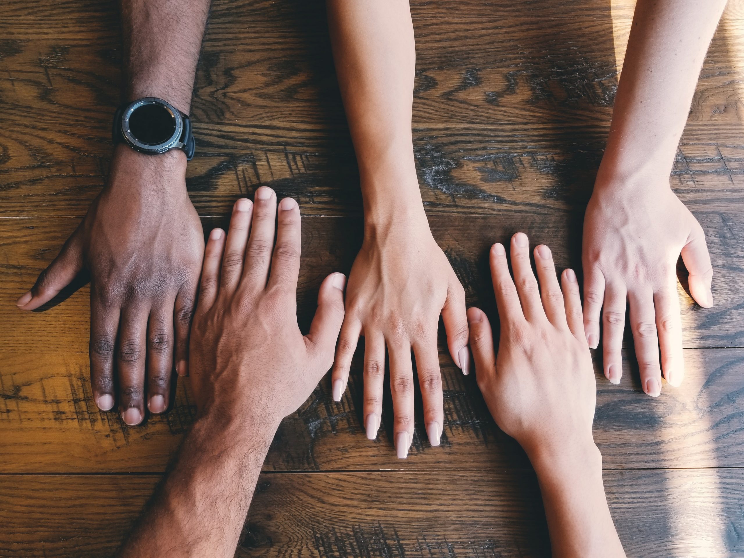 hands on a table to signify support