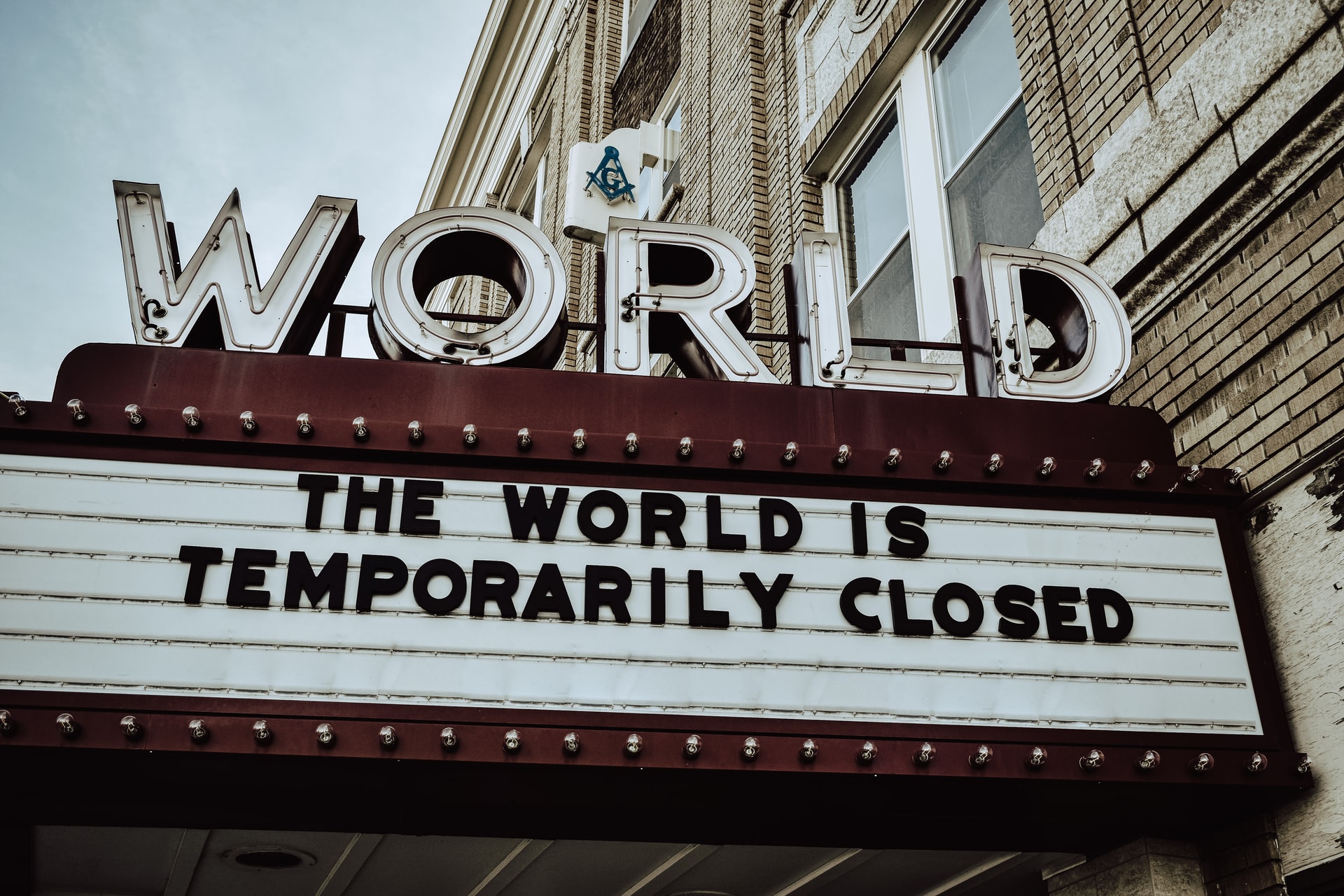 billboard sign with "The World Is Temporarily Closed"