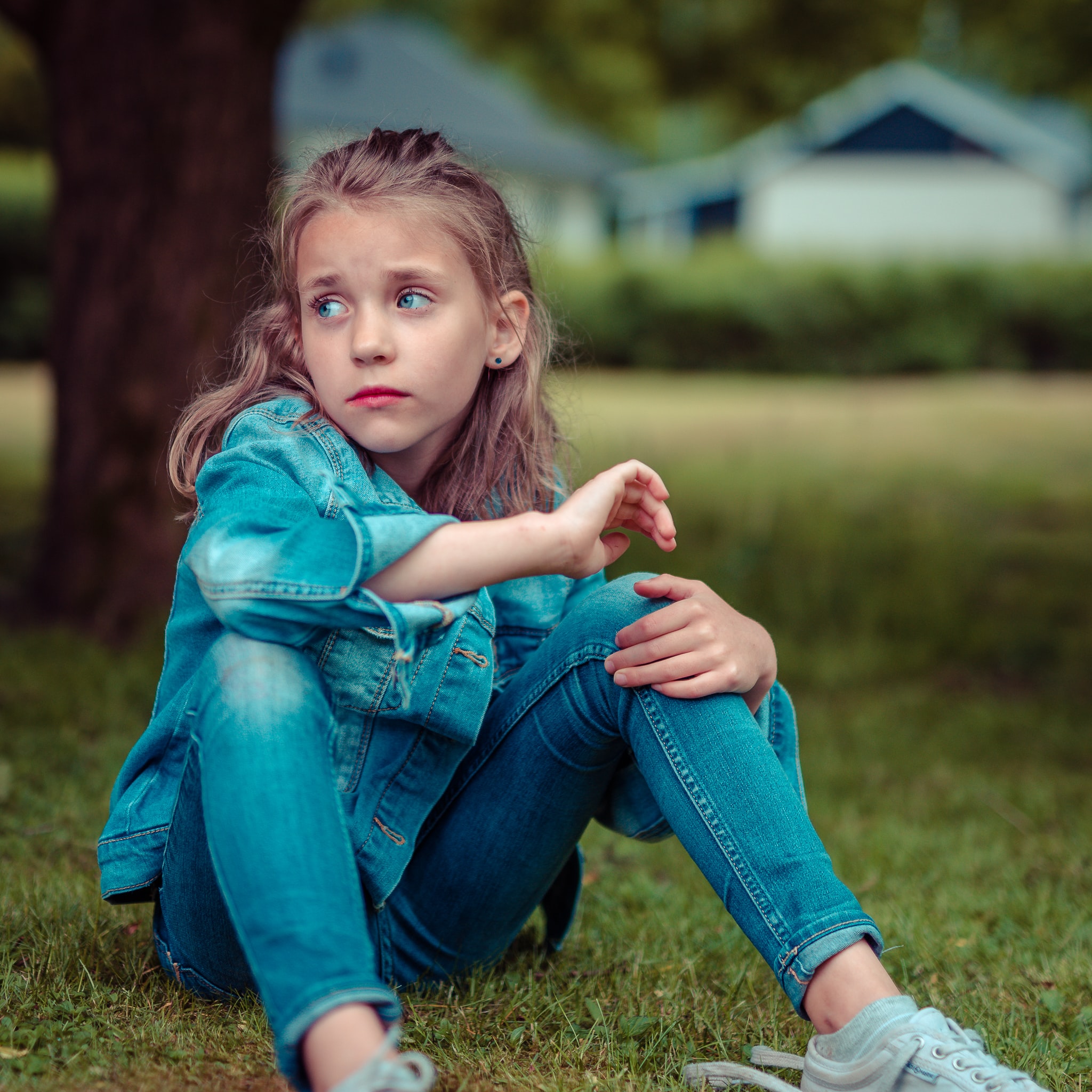 young girl looking away sad