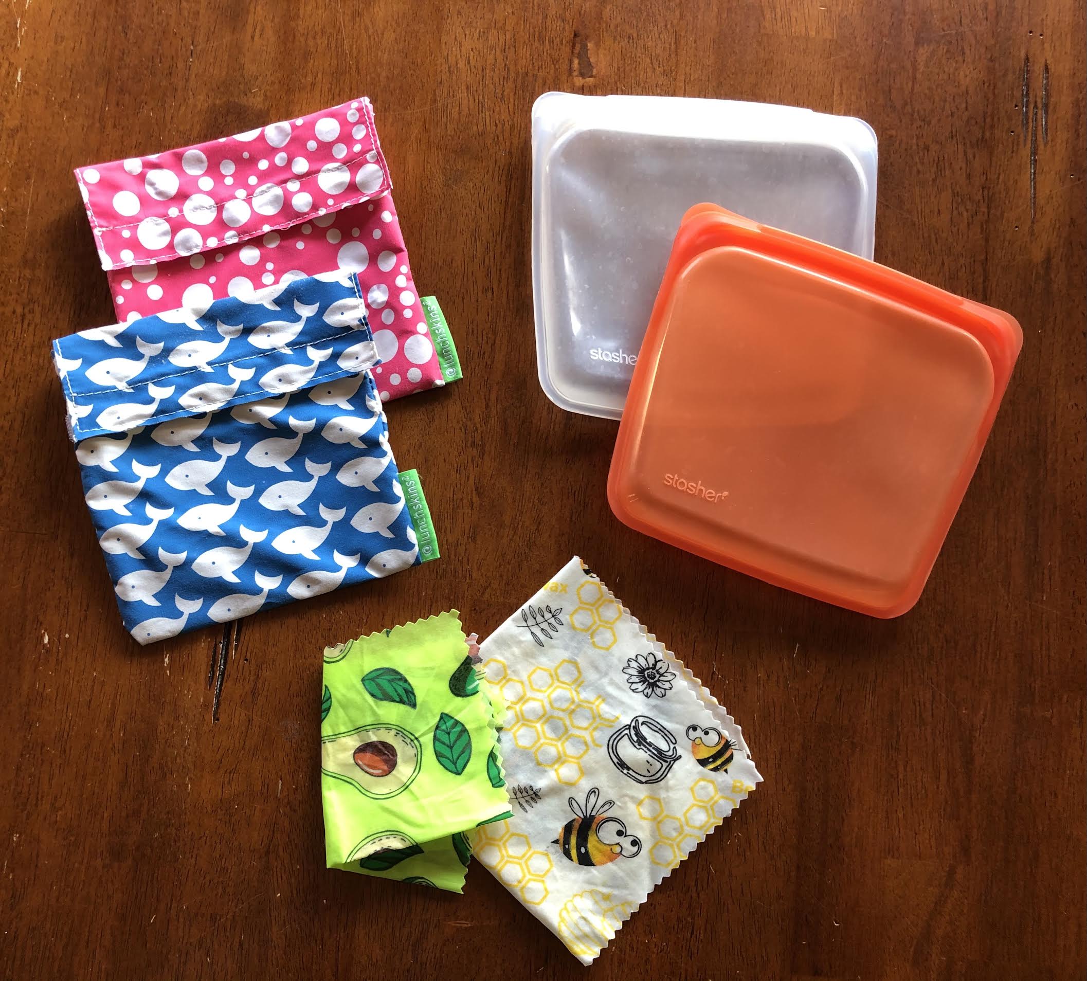 reusable sandwich bags, snack bags, and container covers on a kitchen table