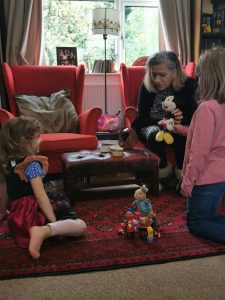 grandmother playing toys with her granddaughters