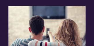 man and woman on couch watching TV