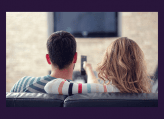 man and woman on couch watching TV