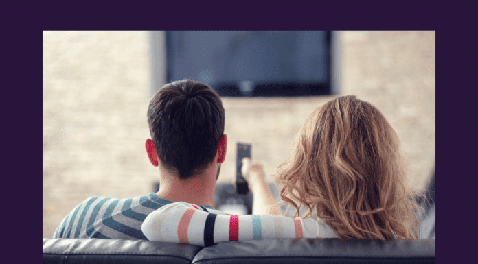 man and woman on couch watching TV