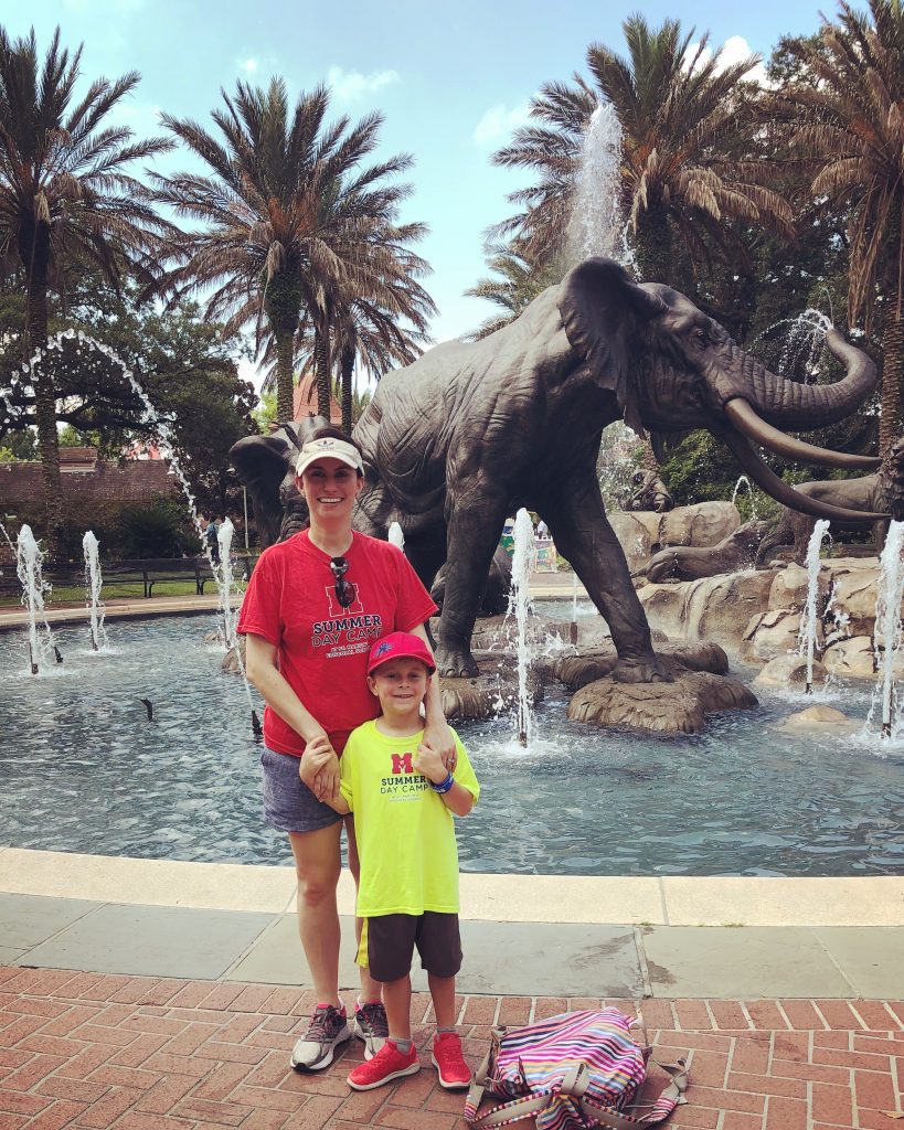 Mother and son at the zoo in front of an elephant statue