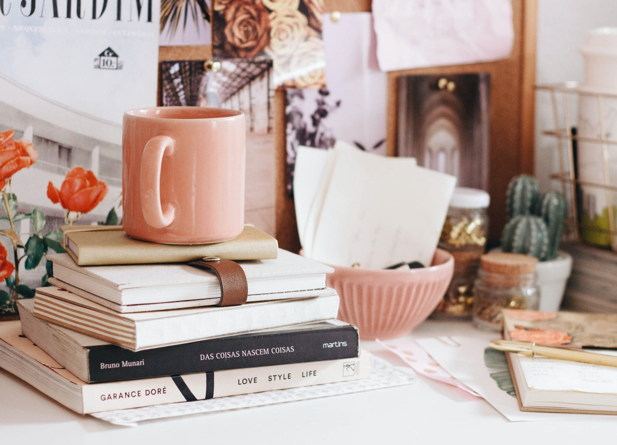 messy desktop with papers and mug