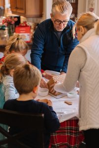 older and younger family members baking together