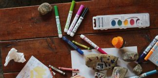 rocks and crayons and markers on a table