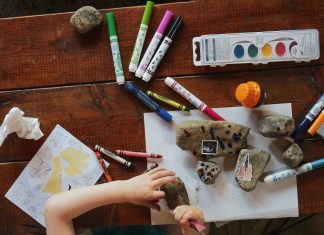 rocks and crayons and markers on a table