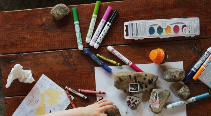 rocks and crayons and markers on a table