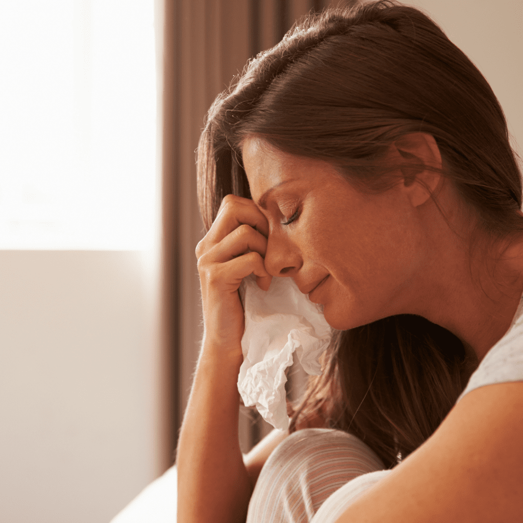 woman crying into a tissue