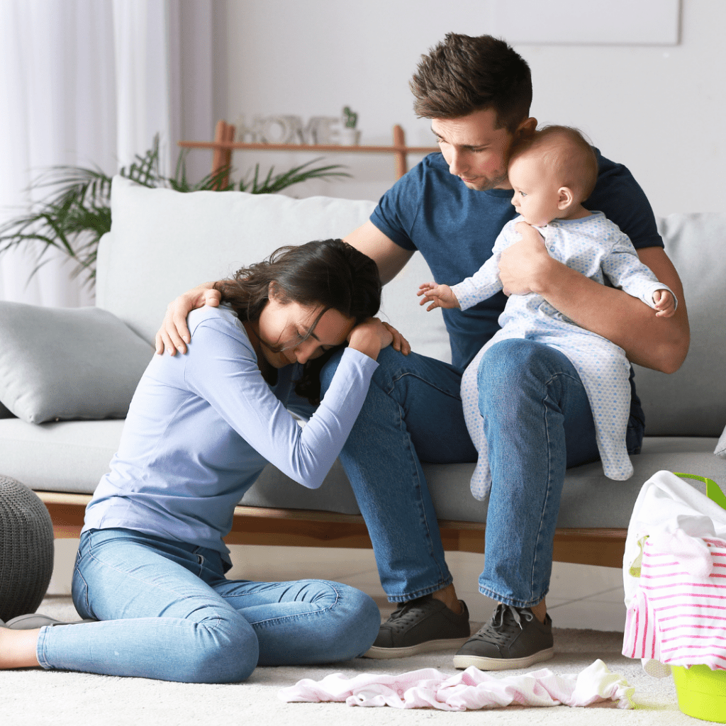 mother crying with father holding baby