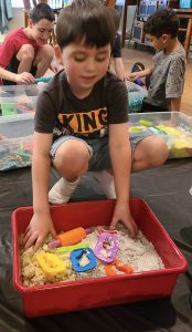 Sensory bin of moon dough