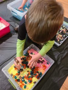 Sensory bin of dried rice, beans, and pasta