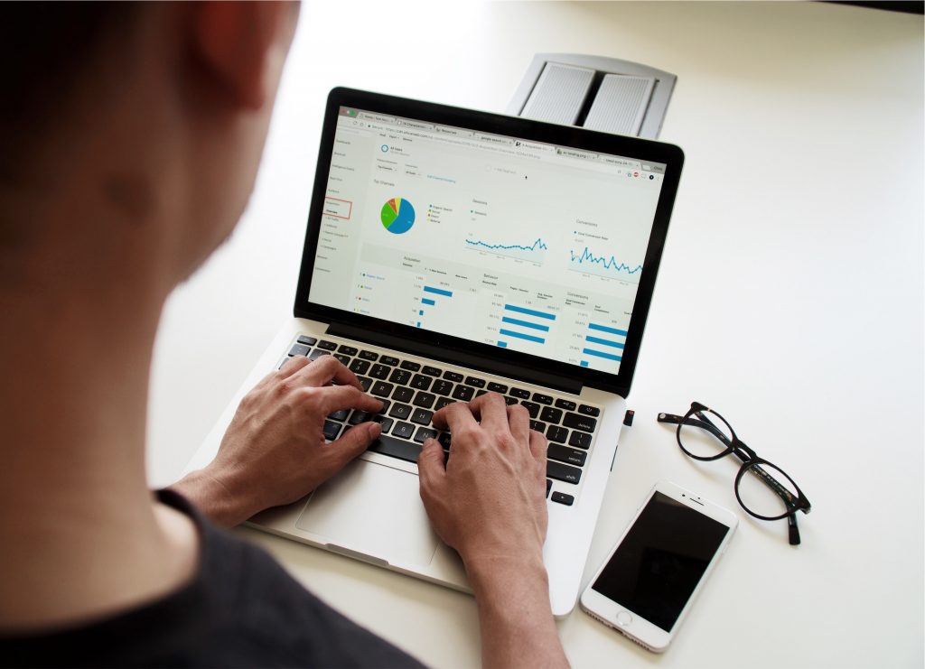 person working on a financial budget on a laptop 