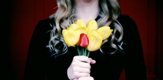 woman holding a bouquet of flowers in black to signify mourning