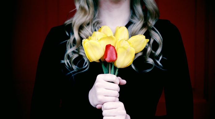 woman holding a bouquet of flowers in black to signify mourning