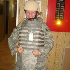 woman in combat uniform smiling