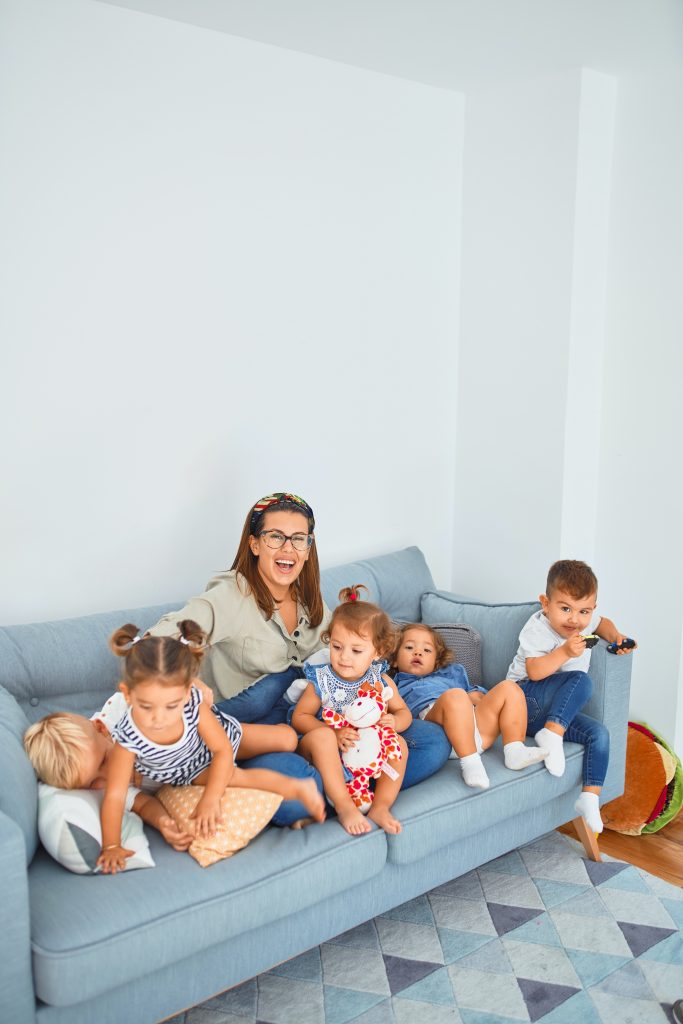 mother with 5 children on a blue couch