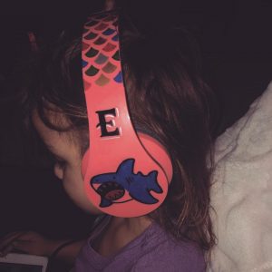 young girl with headphones on