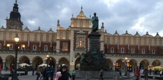 Mother and children standing in the main square of Krakow, Poland 2016