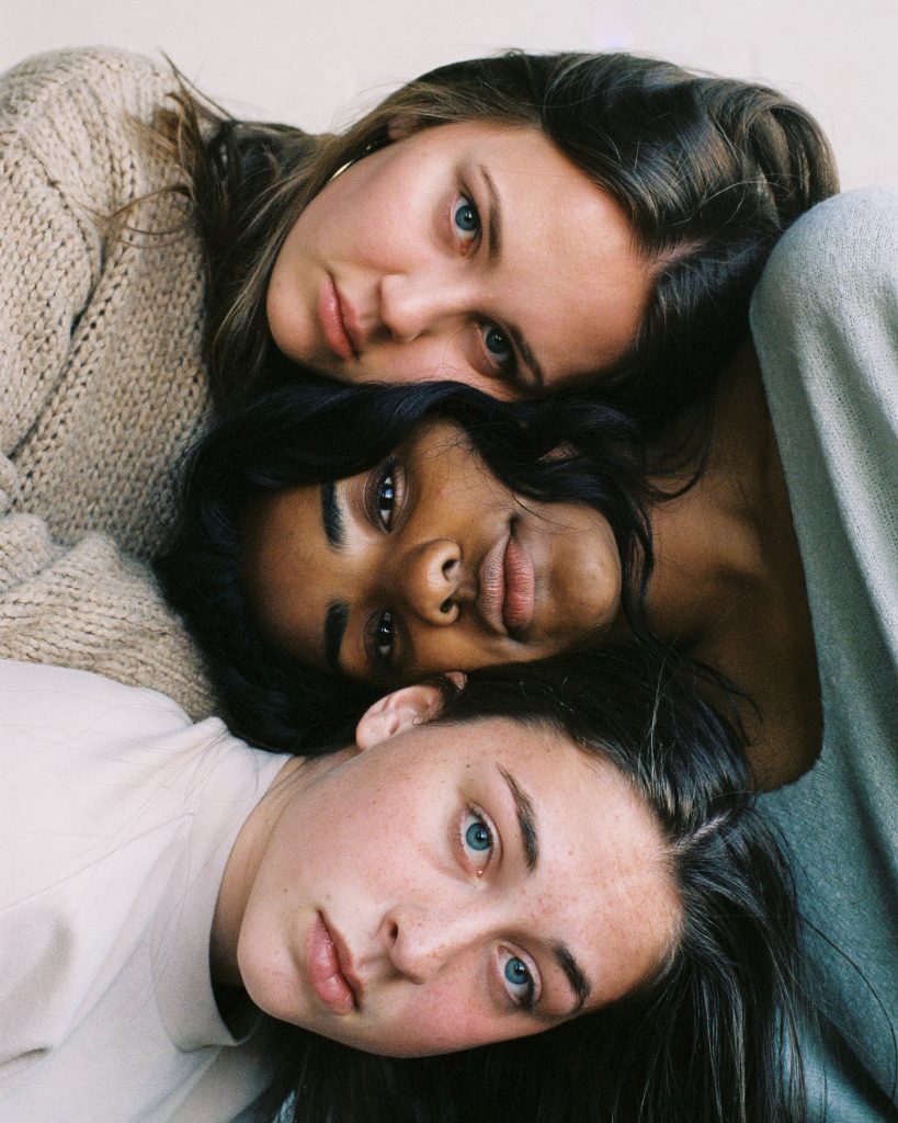 three women laying together