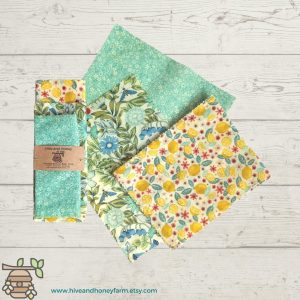 beeswax sustainable wraps in different colors on a wood plank background