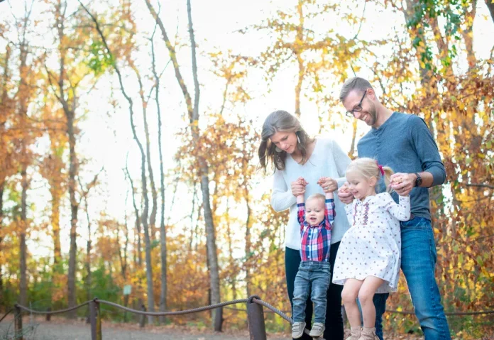walking in fall family with small children walking in fall trees