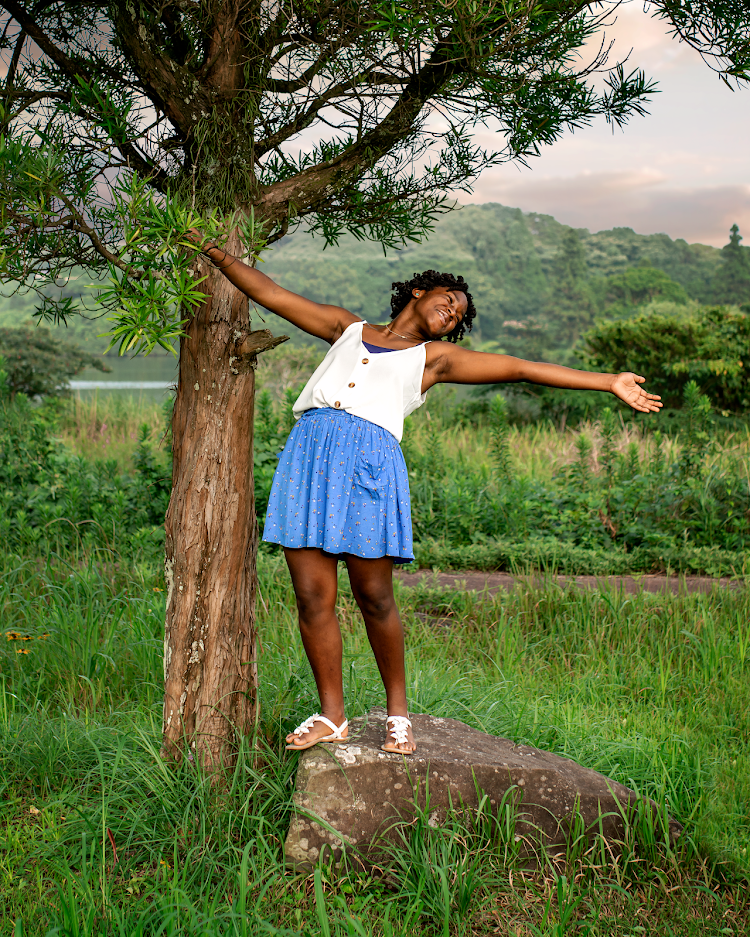 girl standing on a rock in a dance pose