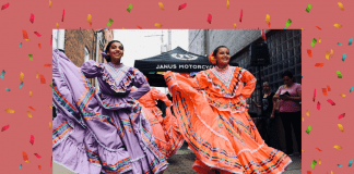 Hispanic dancers in traditional dress with a pale coral background and confetti