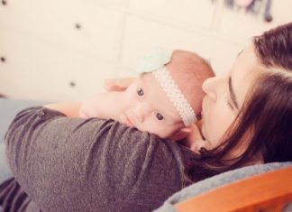 mom holding newborn baby on chest