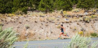 Set Your Own Pace, and You’re Never Last woman running on a road with dusty hillside in the background