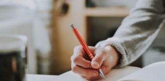 Ideas for Memory Keeping: Baby Books and Beyond Person's hand about to write in a journal