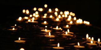 Planning Ahead: What To Do After a Loved One’s Death multiple lit votive candles to symbolize death or mourning