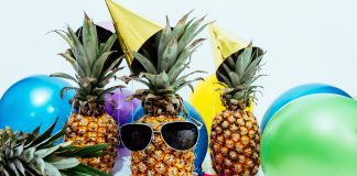 pineapples wearing sunglasses and beach balls