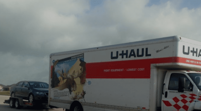 U-Haul truck towing a car and "Moving with Cars During a PCS" in text