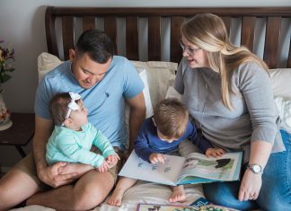 Vidales family sitting on bed together