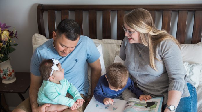 Vidales family sitting on bed together